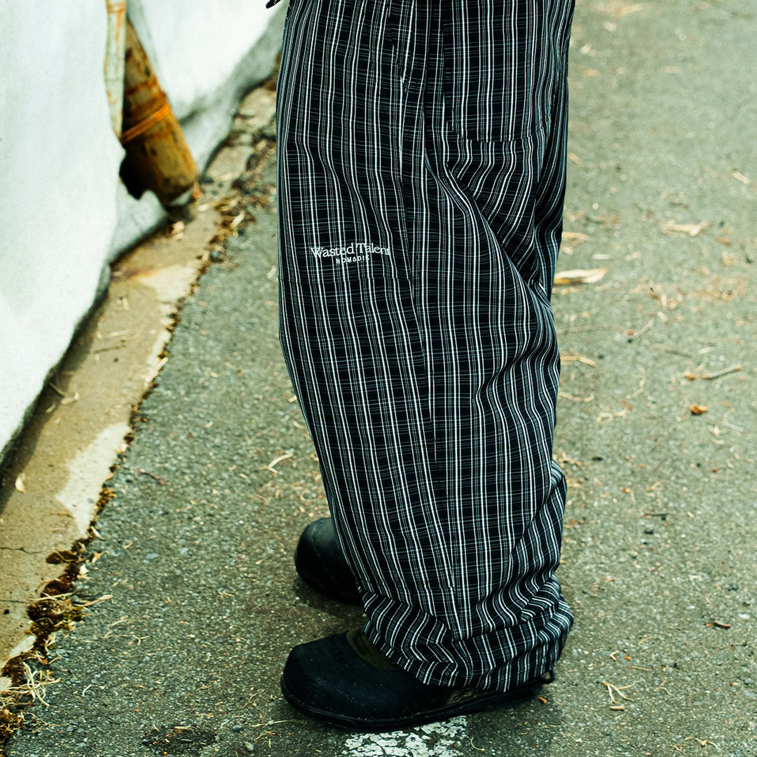 NOMADIK X WASTED TALENT OUTERWEAR PANTS 2026 / GREY CHECK
